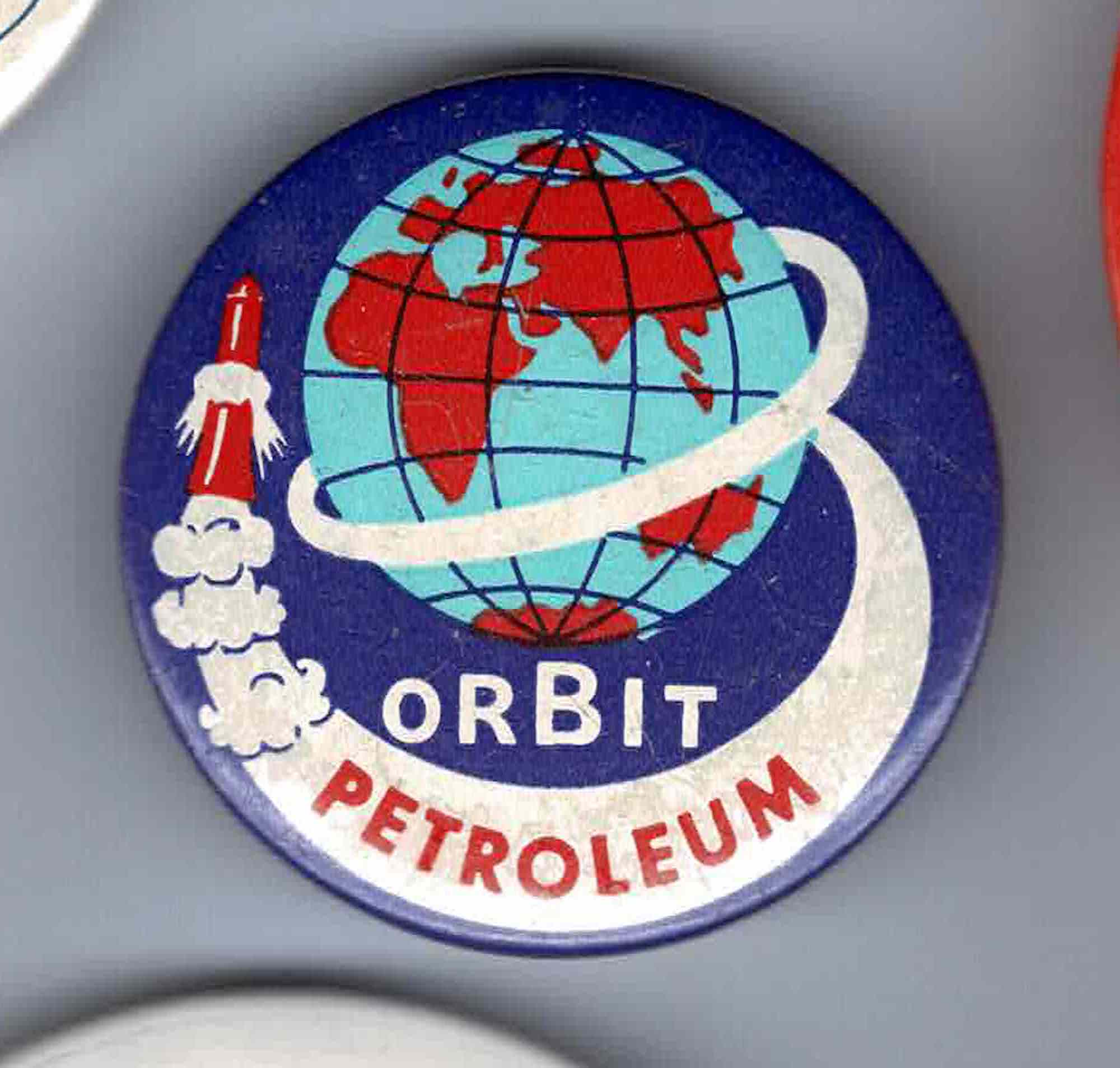 A badge with the words Orbit Petroleum and an image of a world map with a rocket spiralling around it