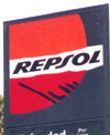 Repsol logo - orange and red sun on grey background