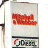 Mitchell & Webber logo, red text with yellow shadow