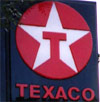 Texaco logo late 1980s to date - black background, red circle with white star and red T